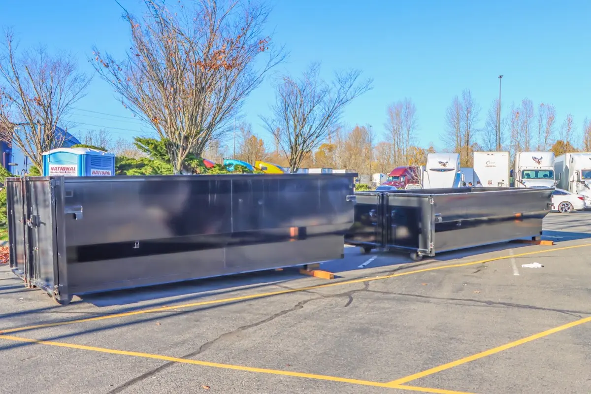 Professional dumpster rental service with roll-off container on residential driveway in Fort Belvoir